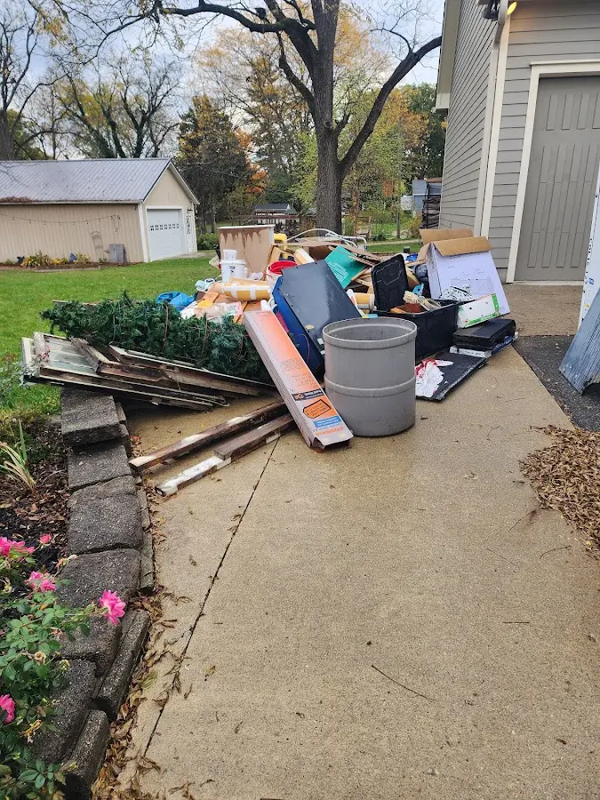 Dumpster being loaded with debris for 12 Yard Dumpster Rental in Hasbrouck Heights